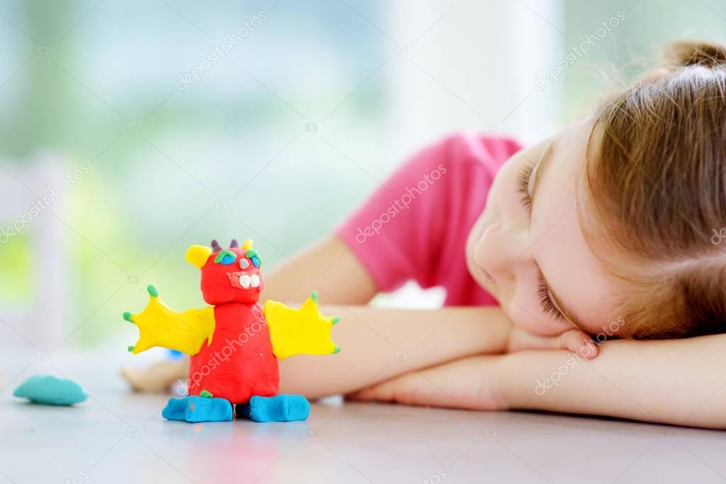 girl with modeling clay figure