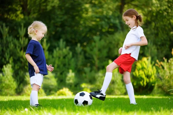Cute little sisters  playing soccer — Stock Photo, Image