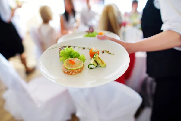 Waiter carrying plate with dish — Stock Photo, Image
