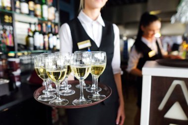 Waitress holding dish of champagne clipart