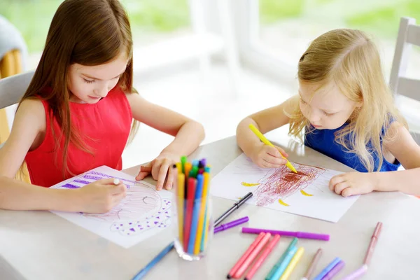 Sisters drawing with pencils Stock Photo