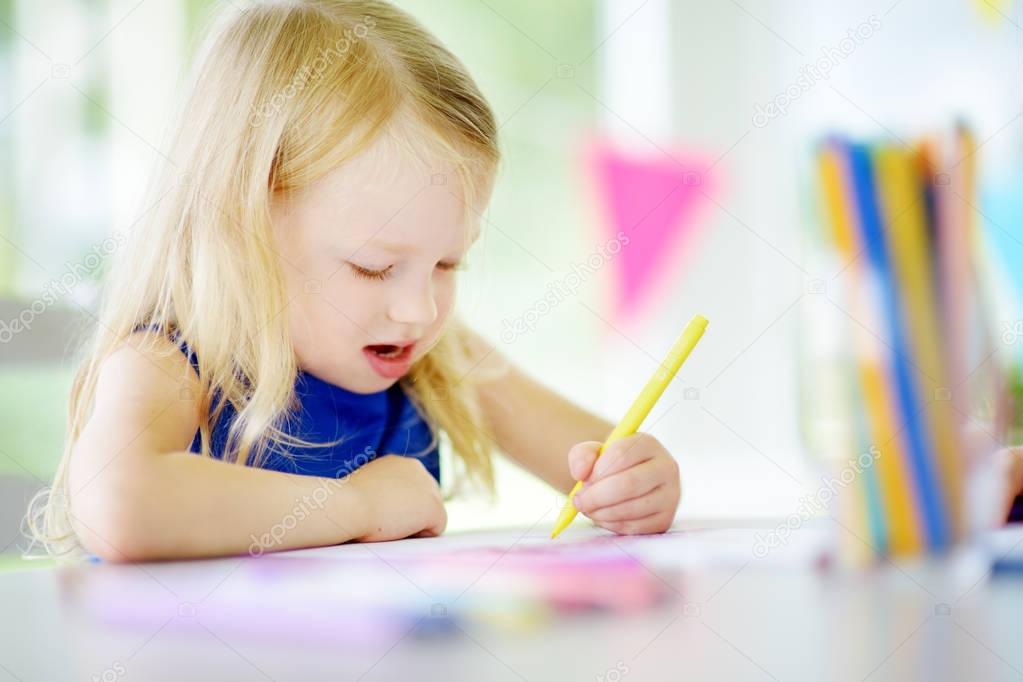 Girl drawing with colorful pencils