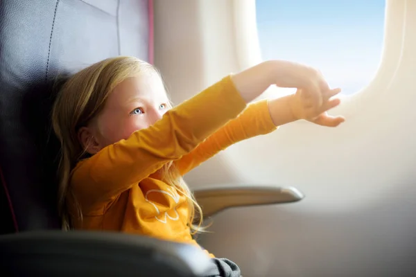 Criança sentada à janela da aeronave — Fotografia de Stock