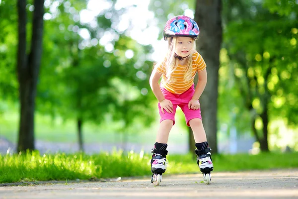 Pretty little girl learning to roller skates — Stock Photo, Image