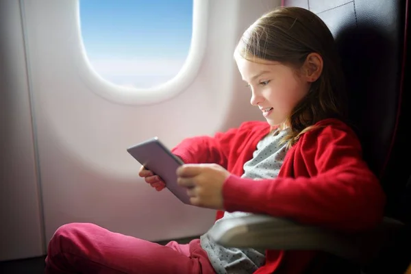 Adorable little girl traveling by an airplane.