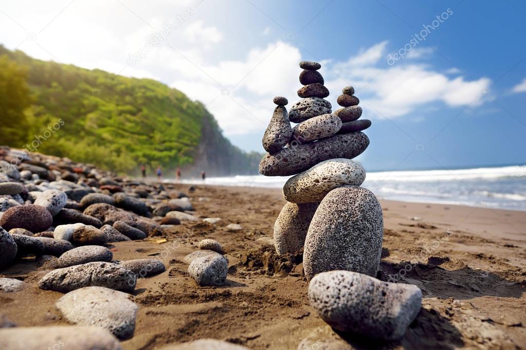 Stack of balanced stones on beach 
