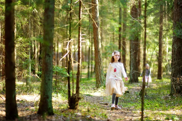 Girls picking flowers in forest — Stock Photo, Image