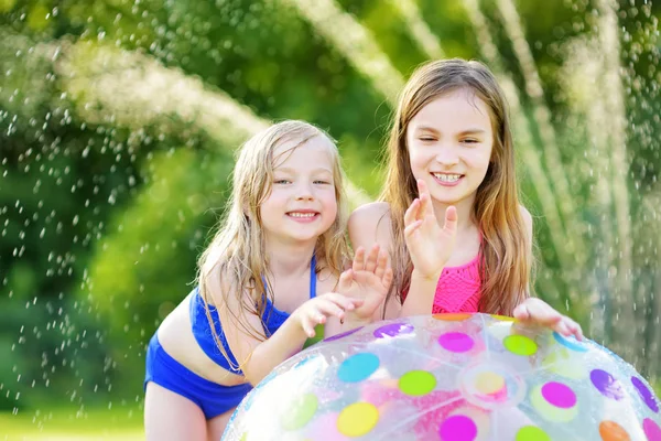 Girls playing with inflatable beach ball — Stock Photo, Image