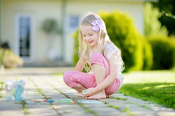 Menina aprendendo a desenhar com giz amarelo — Fotografia de Stock