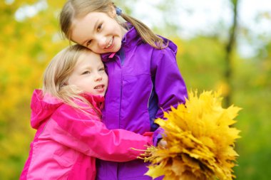 küçük kız sonbahar yaprakları ile oynamak 