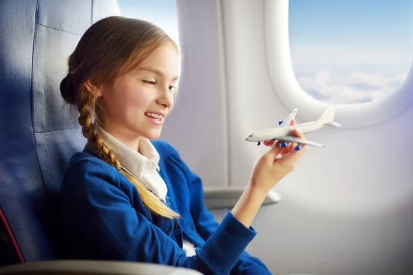 Adorable little child traveling by an airplane — Stock Photo, Image