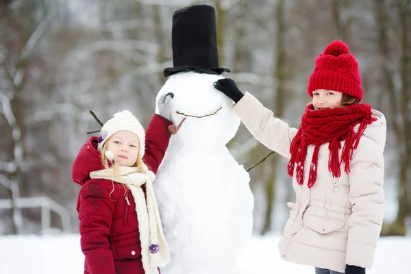 建设一个雪人的小女孩 — 图库照片