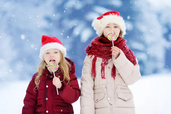 Hermanas teniendo piruletas de Navidad — Foto de Stock