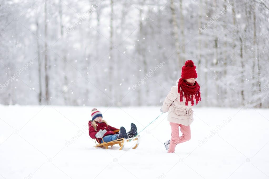 Little girls having fun with sleight 