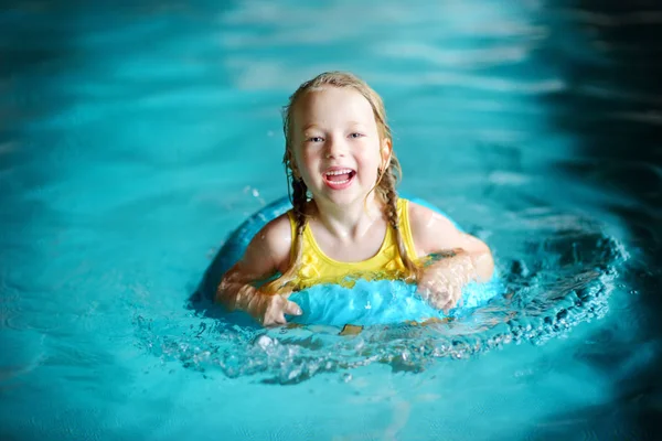 Little girl swimming with inflatable ring — Stock Photo, Image