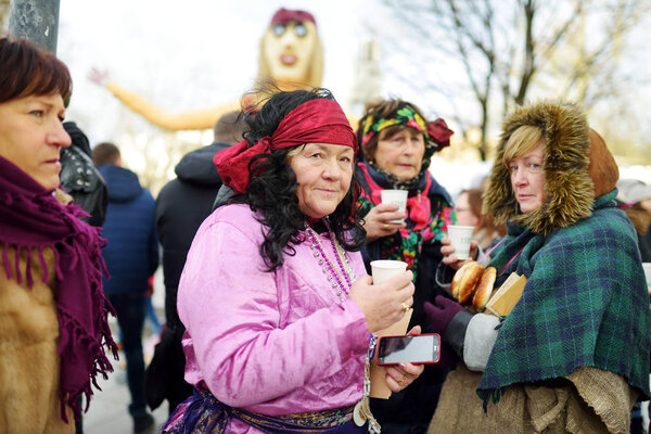 people celebrating Uzgavenes