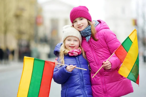 Two Adorable Little Sisters Celebrating Lithuanian Independence Day Holding Tricolor — Stock Photo, Image