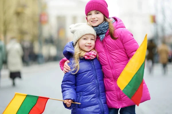 Two Adorable Little Sisters Celebrating Lithuanian Independence Day Holding Tricolor — Stock Photo, Image