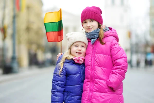 Two Adorable Little Sisters Celebrating Lithuanian Independence Day Holding Tricolor — Stock Photo, Image