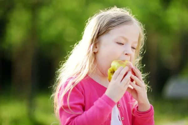 Funny Little Girl Biting Apple Outdoors Warm Sunny Summer Day — Stock Photo, Image