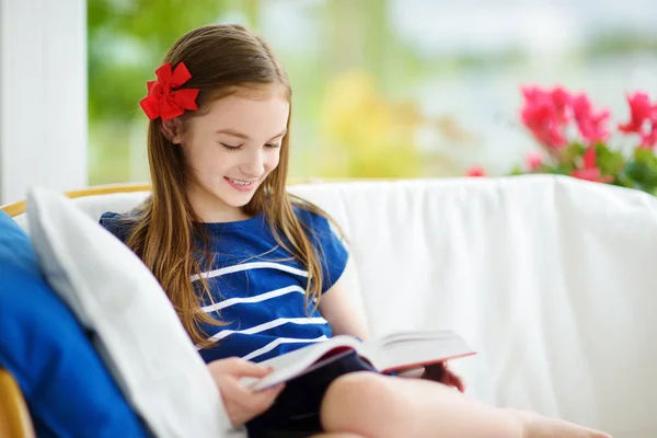 Chica leyendo libro en la sala de estar —  Fotos de Stock