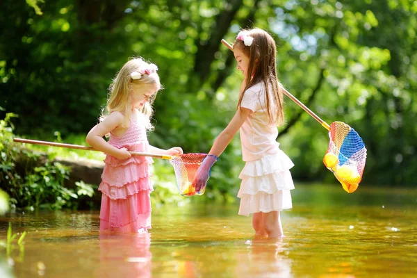 Schattig zusjes spelen in rivier — Stockfoto