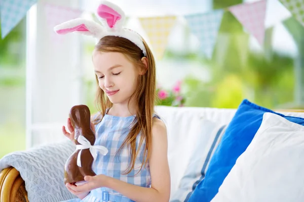 Cute little girl eating Easter rabbit