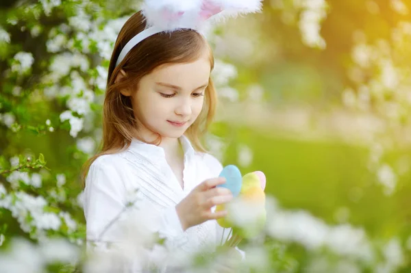 Adorable little girl in blooming garden — Stock Photo, Image