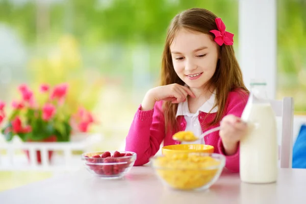 Mała dziewczynka jeść płatki kukurydziane — Zdjęcie stockowe
