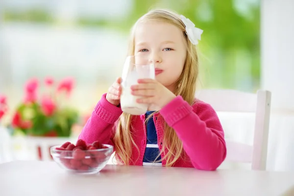 Little girl drinking milk at home — Stock Photo, Image