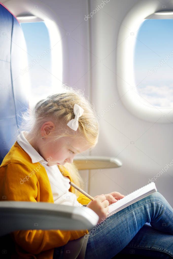 little girl traveling by airplane 