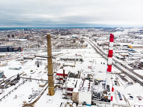 Aerial view of biofuel boiler-house plant facilities with steaming chimneys on chilly winter day in Klaipeda, Lithuania