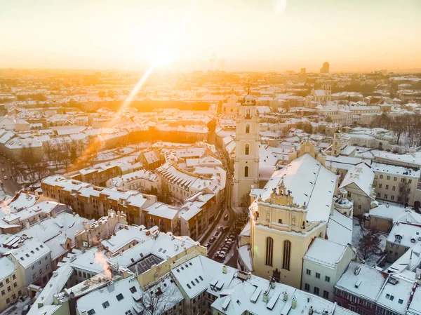 Beautiful Vilnius city panorama in winter with snow covered houses, churches and streets. Aerial evening view. Winter city scenery in Vilnius, Lithuania.