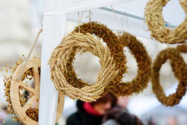 Traditional Lithuanian straw wreaths sold on Easter market in Vilnius. Lithuanian capital's annual traditional crafts fair is held every March on Old Town streets. clipart