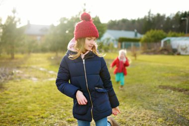 İki genç kız kardeş güzel bir bahar gününde birlikte eğleniyorlar. Çocuklarla aktif aile eğlencesi. Aile eğlencesi..