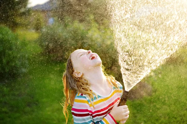 Adorable Niña Jugando Con Una Manguera Jardín Cálido Día Verano — Foto de Stock