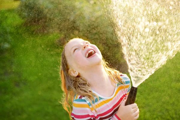 Adorable Niña Jugando Con Una Manguera Jardín Cálido Día Verano — Foto de Stock