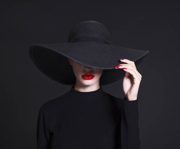 Luxury woman in a large black hat 