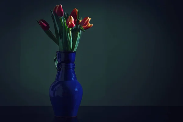 Ramo Tulipanes Rojos Jarrón Azul Sobre Fondo Oscuro — Foto de Stock