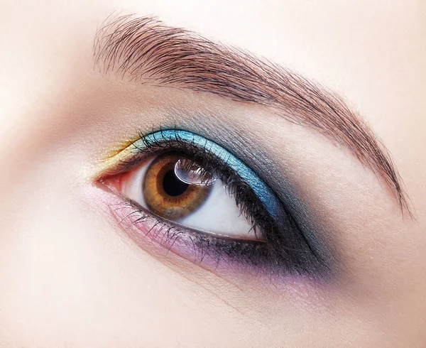 Closeup macro shot of human female eye. Girl with perfect skin a