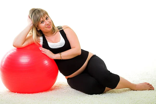 Pregnant woman with red gymnastic ball — Stock Photo, Image
