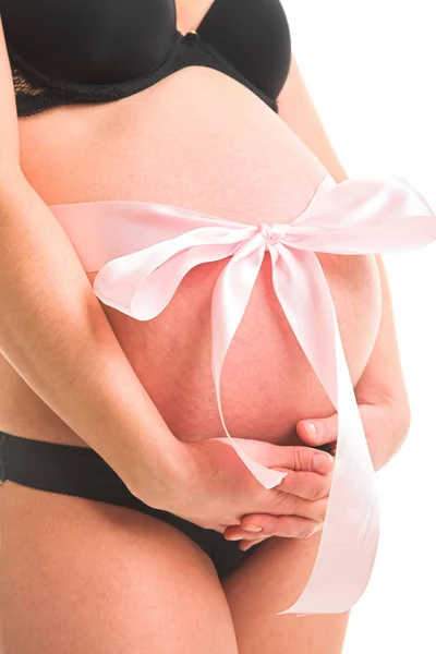 Pregnant woman with ribbon around belly — Stock Photo, Image
