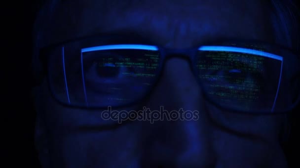 Computer code reflecting in eyeglasses — Stock Video