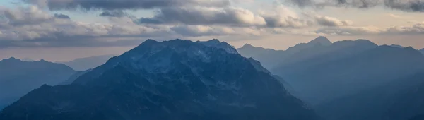 Panorama of mountains in light of evening sun. Range Makera.