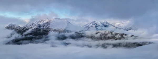 Morgendämmerung hoch oben in den Bergen an einem nebligen Morgen. Kaukasusgebirge. — Stockfoto