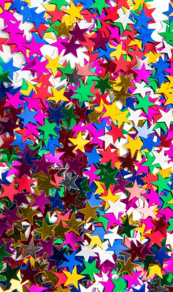 Konfetti Hintergrund von kleinen farbigen Sternen — Stockfoto