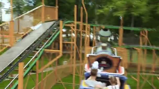 People ride in park attractions a roller coaster — Stock Video