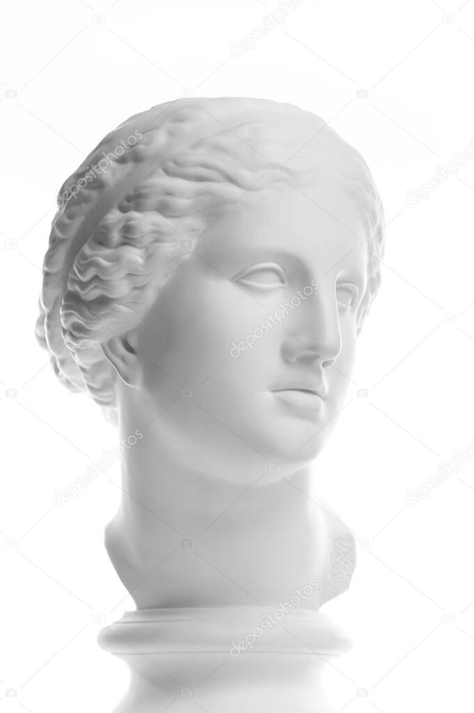 Gypsum copy of ancient statue Venus head isolated on white background. Plaster sculpture woman face.