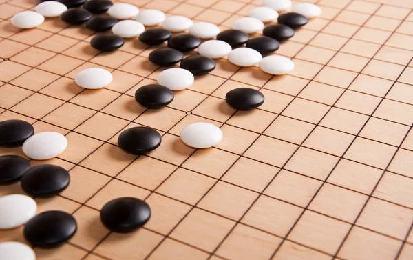 Desk for board game Go (wei-chi) and black and white bones. Traditional asian strategy board game