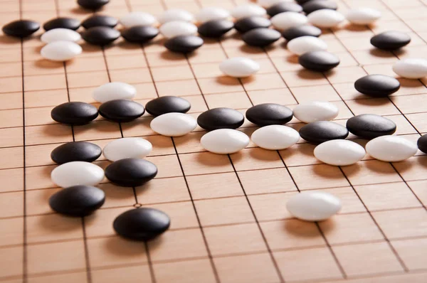 Desk for board game Go (weiqi) and black and white bones. Traditional asian strategy boardgame